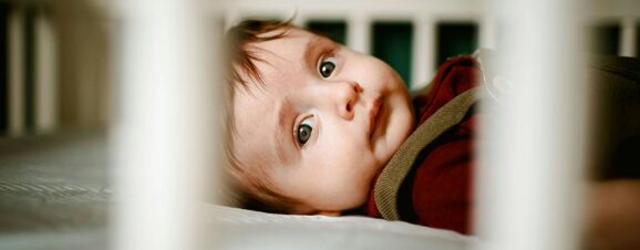 Baby lying in his crib, unable to sleep.
