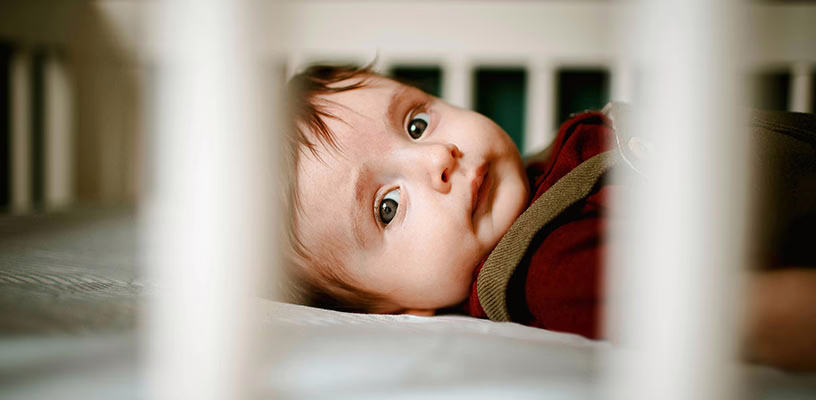 Baby lying in his crib, unable to sleep.