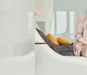 Woman sitting down and resting to get her Braxton Hicks contractions under control.