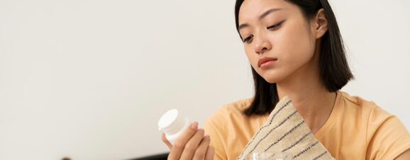 Woman examining a bottle of Tylenol to check if she can take it while pregnant.