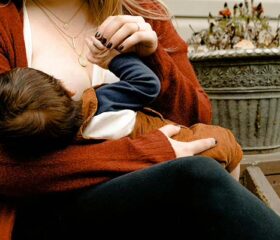 Mom breastfeeding her baby who is in the cluster feeding stage.