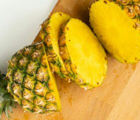Slices of pineapple on a cutting board.