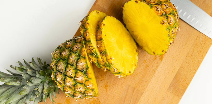 Slices of pineapple on a cutting board.