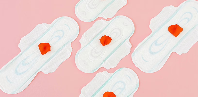 Five pads with rose petals on them representing implantation bleeding.