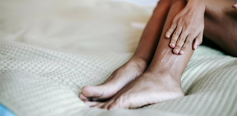 Close view of a woman massaging areas of postpartum swelling in her ankles.