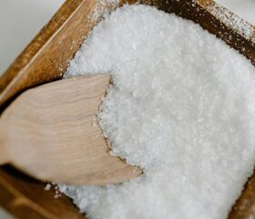 Wooden spoon in a bin of salt.