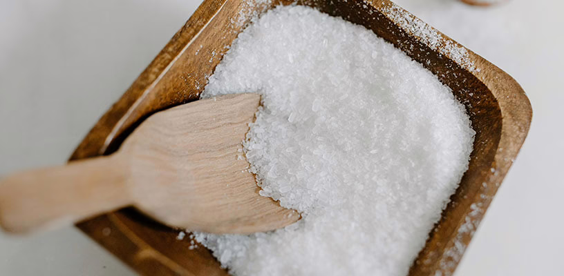 Wooden spoon in a bin of salt.