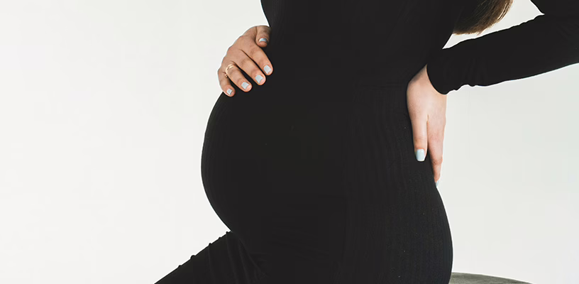 Woman experiencing round ligament pain.