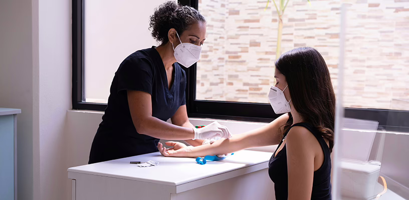 Woman receiving a glucose test for gestational diabetes.