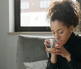 A woman drinking tea as she tries to cope after her miscarriage.