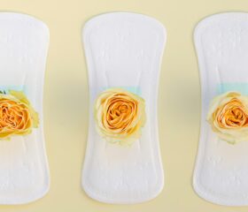 Three pads with yellow roses on them to represent yellow discharge during pregnancy.