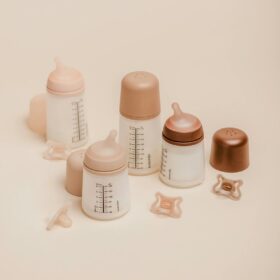 Various bottles and pacifiers of different sizes from the Suavinex Zero Zero Anti-Colic Bottle set.