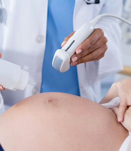 Woman at the doctor's office about to receive an ultrasound.