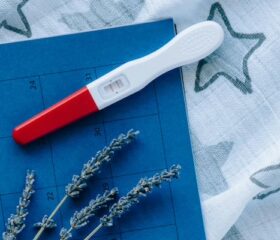 Ovulation test strip lying on a calendar.