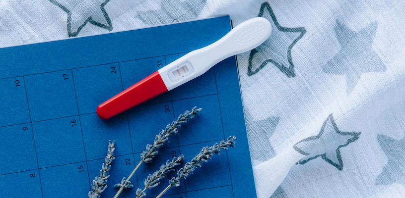Ovulation test strip lying on a calendar.