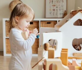 Small toddler picking up blocks, demonstrating the pincer grasp.
