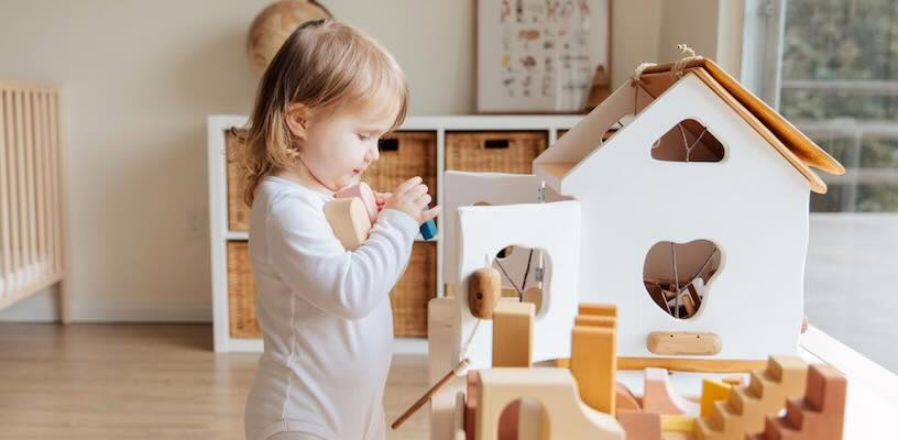 Small toddler picking up blocks, demonstrating the pincer grasp.