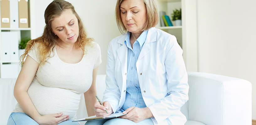 Woman speaking with her doctor about her subchorionic hematoma.