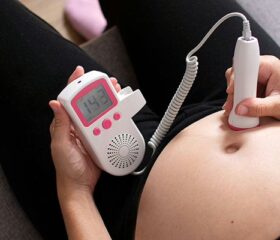 Pregnant woman monitoring her own baby's heartbeat.