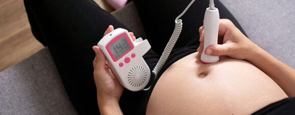 Pregnant woman monitoring her own baby's heartbeat.