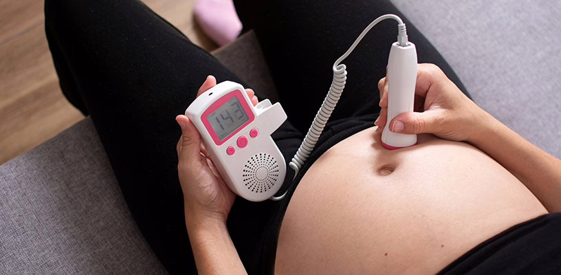 Pregnant woman monitoring her own baby's heartbeat.