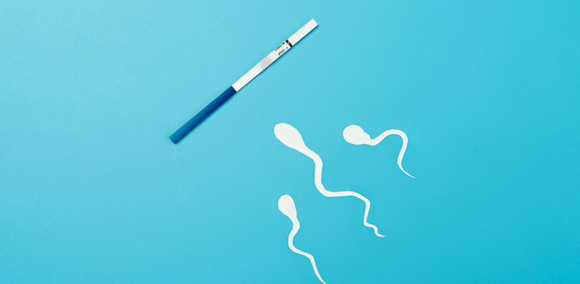 Illustrated sperm swimming towards an ovulation test strip against a blue background.
