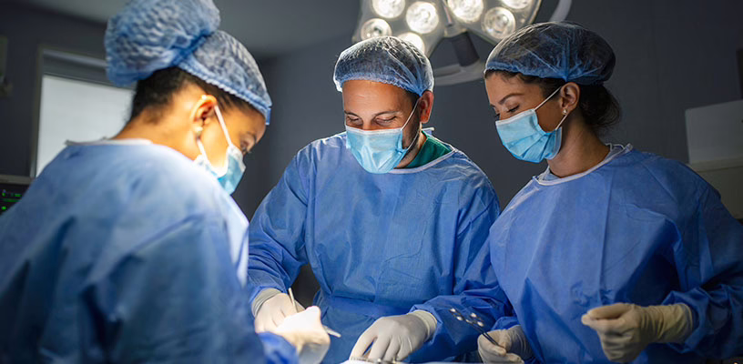 Room of surgeons performing a C-section on a soon-to-be mother.