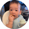 10-month-old baby sitting in high chair and eating snack.