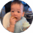 10-month-old baby sitting in high chair and eating snack.
