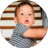 11-month-old baby sitting at the bottom of the stairs.