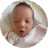 Sleepy two-week-old baby yawning with eyes half open.