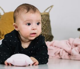 A 3-month-old baby raising his head during tummy time.