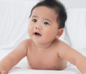 A 4-month-old baby raising his head during tummy time.