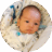 Five-week-old baby lying in bassinet and looking sideways.
