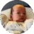 Swaddled six-week-old baby lying on pillow.