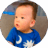 Seven-month-old baby sitting up in couch and looking around.