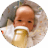 Seven-week-old baby propped up against pillow while drinking from bottle.