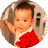 Eight-month-old baby sitting on mother's lap in train.