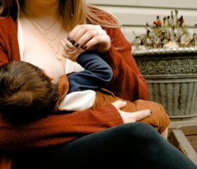 A woman with a clogged Montgomery gland breastfeeding her baby.