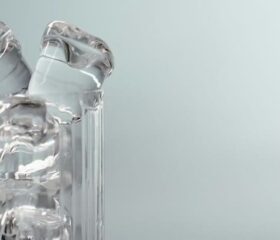 A glass cup full of ice chips.