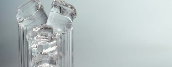 A glass cup full of ice chips.
