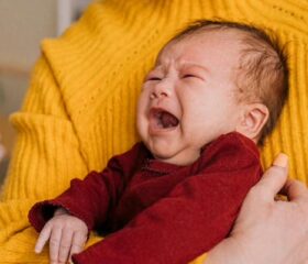 Gassy baby crying before being given gripe water.
