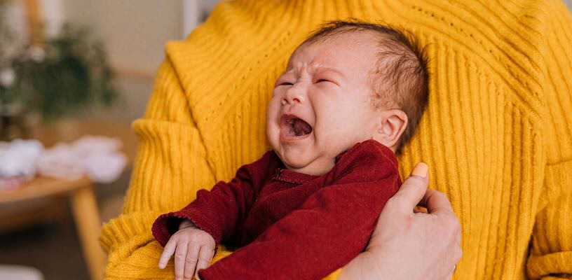 Gassy baby crying before being given gripe water.