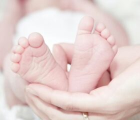 Close-up of a newborn baby's feet (representing the feet-first breech position).