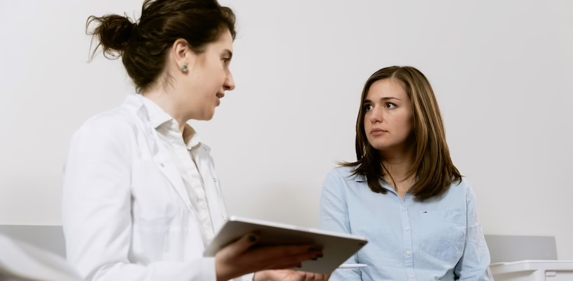 Doctor explaining the the chorionic villus sampling procedure to a pregnant woman.