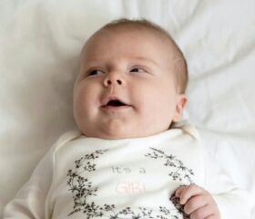 Baby with Epstein pearls lying on his back.