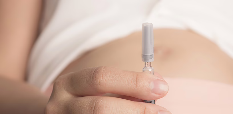 Woman holding vial of donor sperm before undergoing IUI.