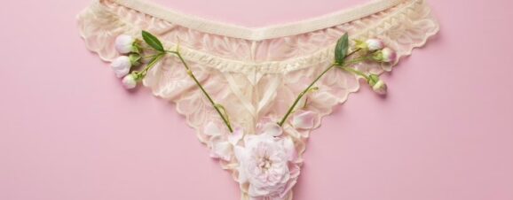 Pink-white flowers on an underwear symbolizing ovulation discharge.
