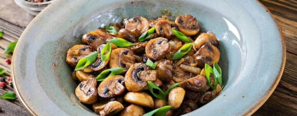 Bowl of cooked mushrooms, which would be safe for pregnant women to eat.