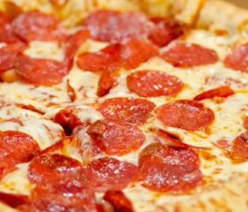 A pizza topped with pepperoni, which pregnant women can only eat if thoroughly cooked.